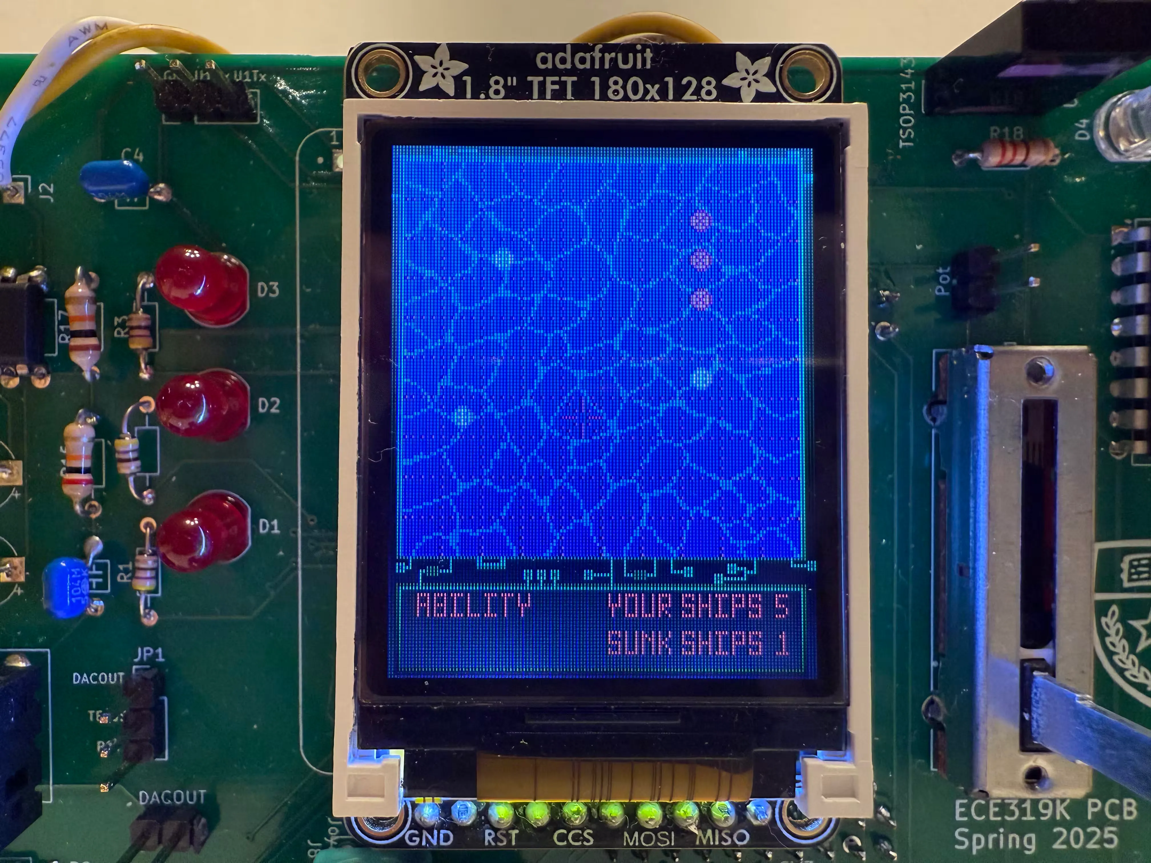 Battleship project PCB, showing the screen with a battleship board showing hits.